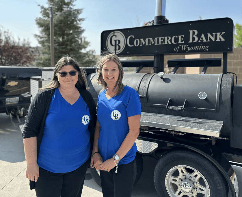 commerce bank of wyoming employees in front of a bbq smoker