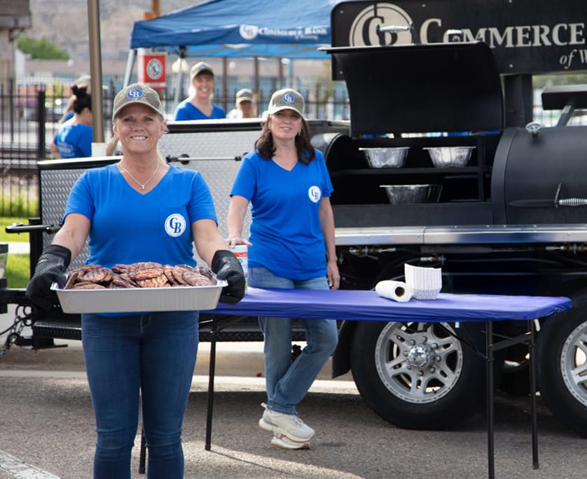 commerce bank of wyoming employees holding food they made for event