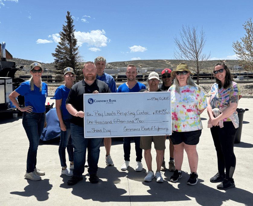 Group holding oversized check from commerce bank of wyoming