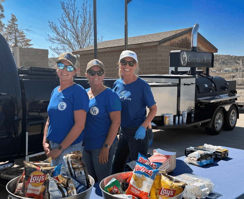 Three women in commerce bank of wyoming shirts