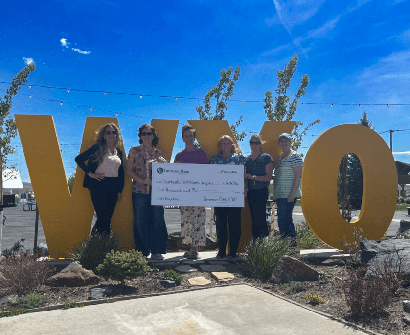 Group holding oversized check from commerce bank of wyoming